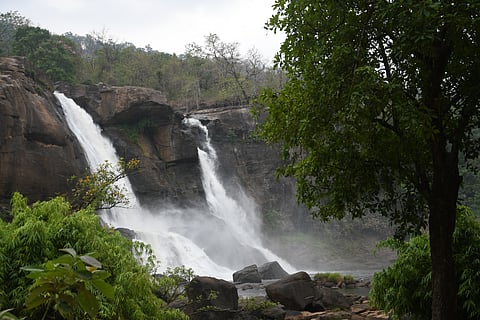 The Athirappilly Falls throw up a light mist